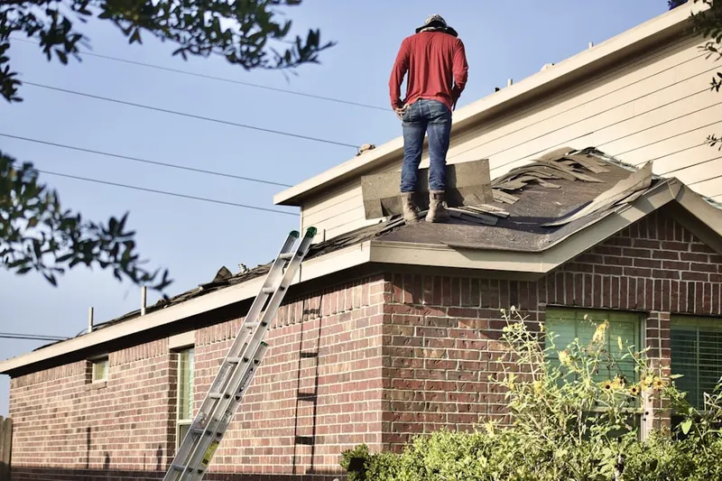 Professional roofer working on a residential roof in Shingle Creek